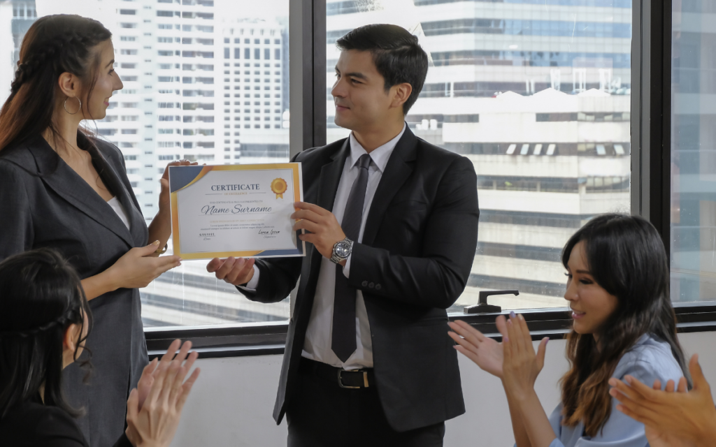 image of man receiving certificate from woman